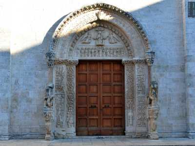 Quello centrale, riccamente fregiato, � considerato il pezzo di maggior pregio del prospetto. Realizzato nel 300 in calcare, sfoggia una rappresentazione scultorea dei testi biblici e si compone di tre �strati� terminanti in arco a sesto acuto